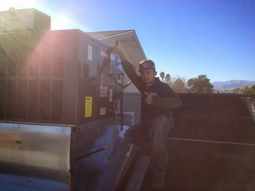 HVAC technician performing HVAC Inspection on a rooftop unit in West Pleasant View